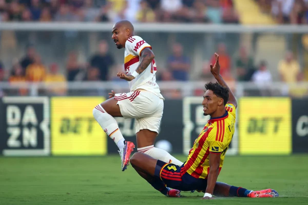 Lecce player tackling AS Roma opponent Lecce player tackling AS Roma opponent