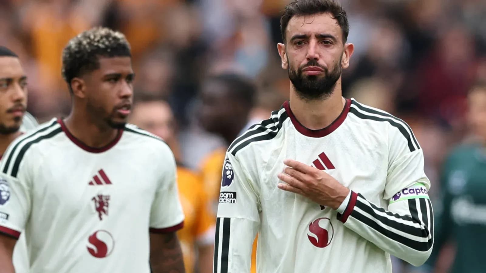 Two players walking off the pitch after match Two players walking off the pitch after match