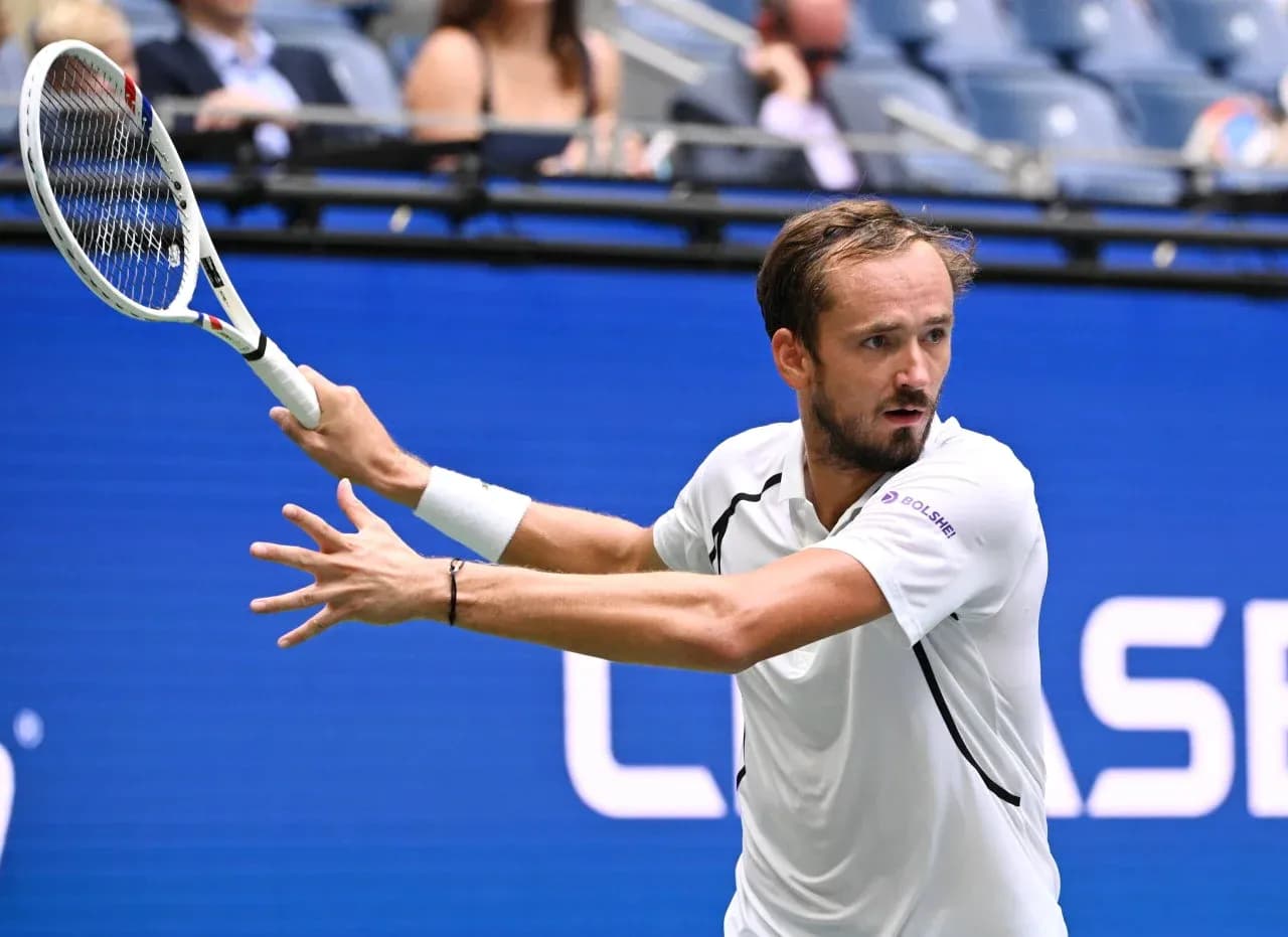 Tennis player hitting a backhand shot during match Tennis player hitting a backhand shot during match