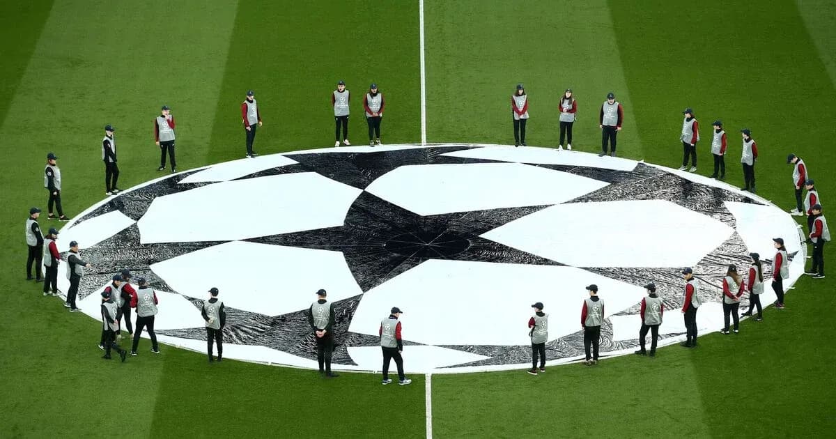 Ground staff preparing Champions League logo before match Ground staff preparing Champions League logo before match