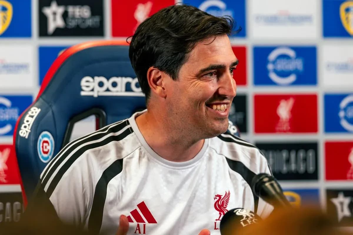 Manager speaking at press conference with Liverpool branding Manager speaking at press conference with Liverpool branding