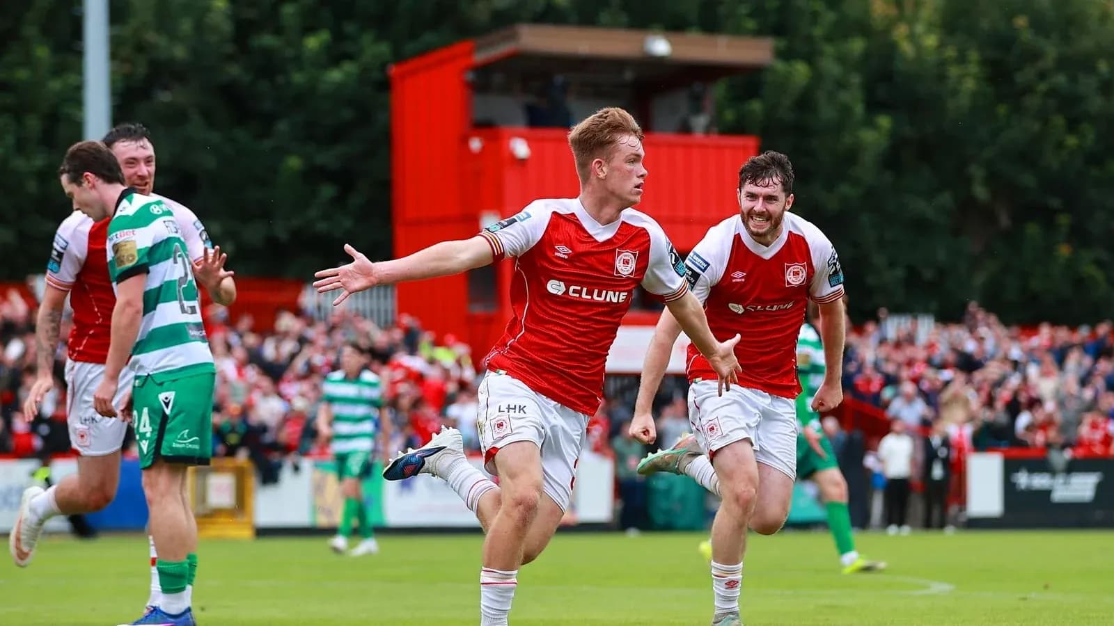 Player celebrating goal with teammates on field Player celebrating goal with teammates on field