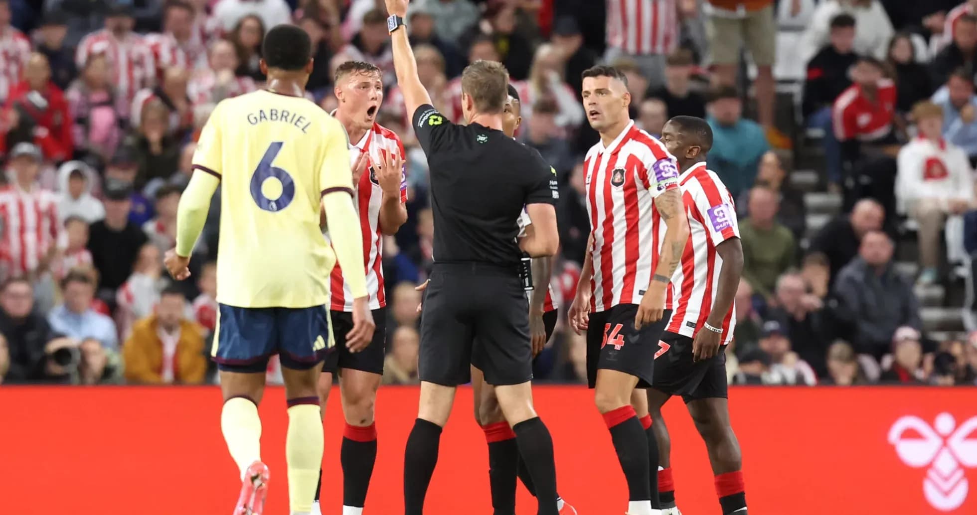 Referee showing yellow card during Sunderland match Referee showing yellow card during Sunderland match