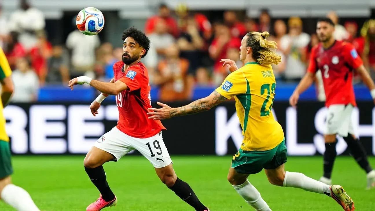 Egyptian player dribbling past Australian defender during match Egyptian player dribbling past Australian defender during match