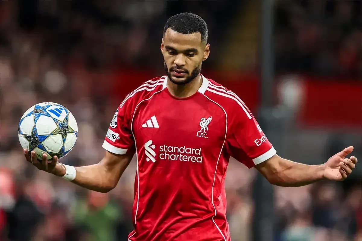 Player in Liverpool kit holding a football Player in Liverpool kit holding a football