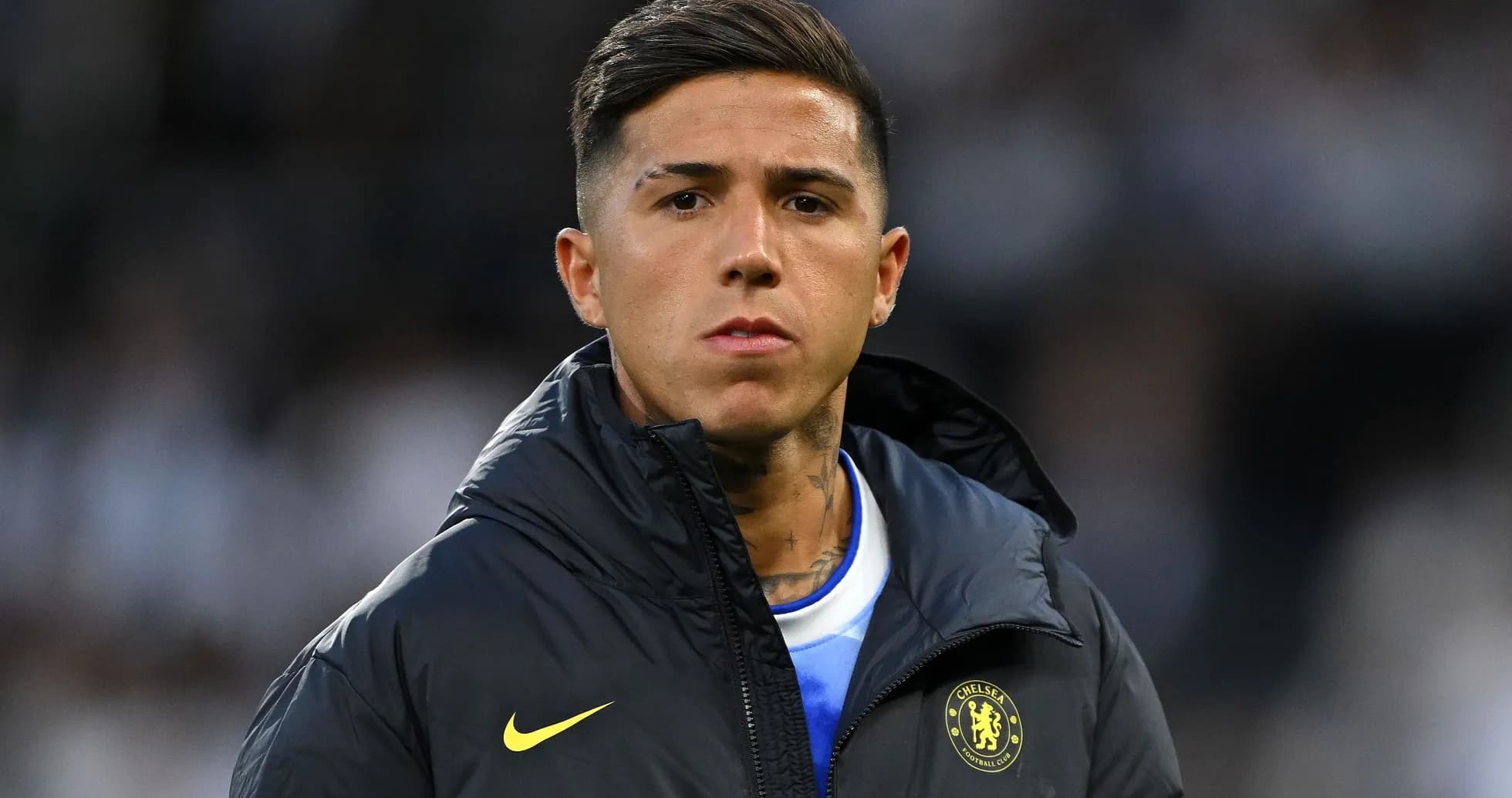 Player in Chelsea jacket on sidelines during match Player in Chelsea jacket on sidelines during match
