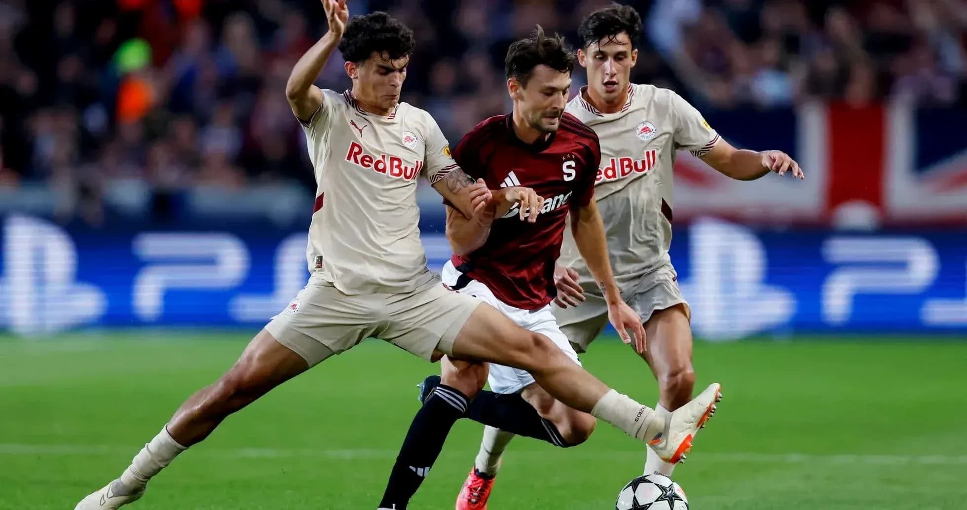 Players competing for the ball in Europa League match Players competing for the ball in Europa League match