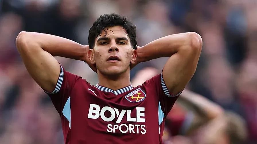 Player in claret jersey with hands on head Player in claret jersey with hands on head