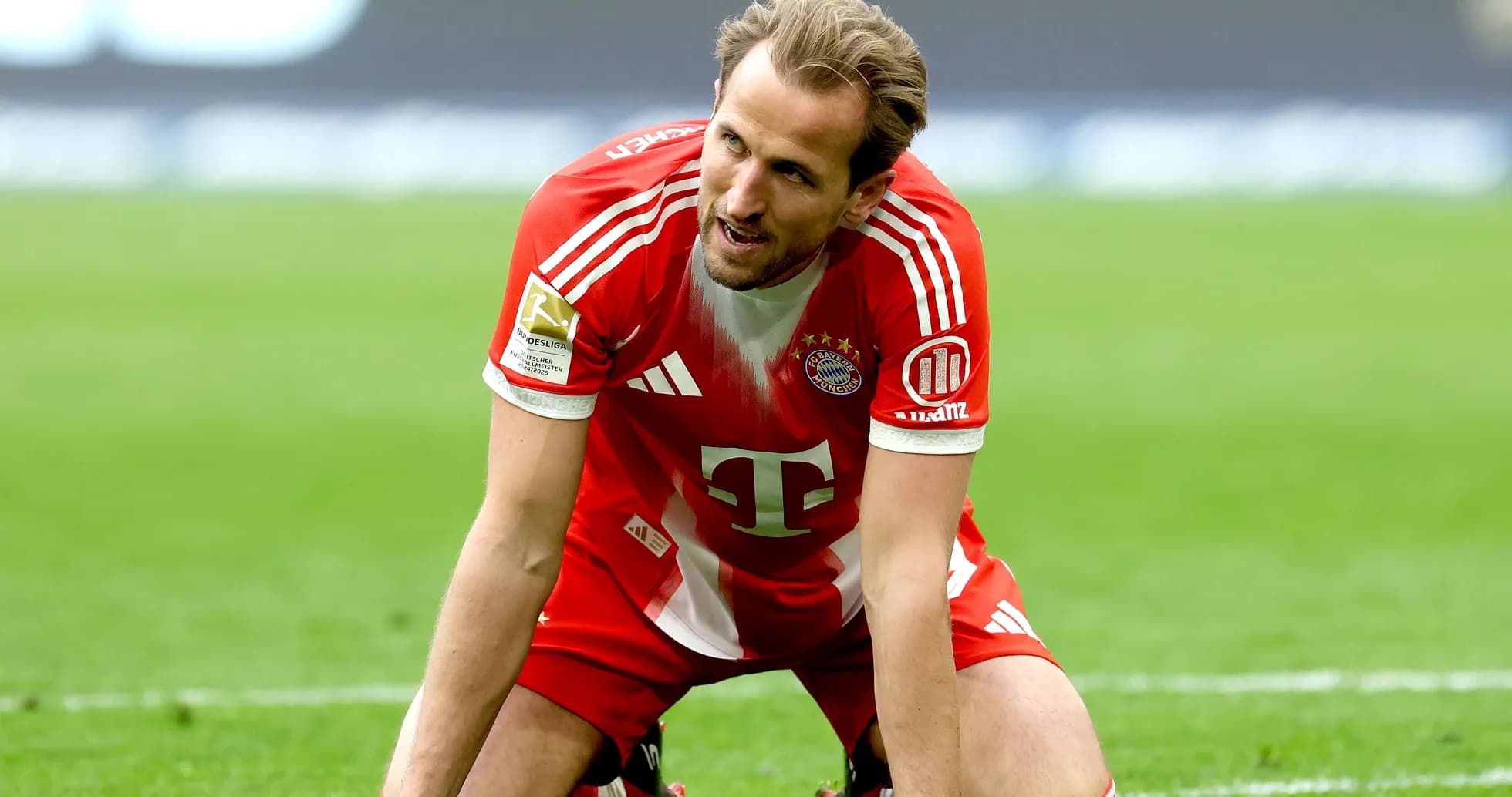 Player in Bayern Munich kit kneeling on field Player in Bayern Munich kit kneeling on field
