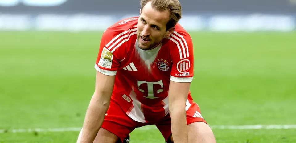Player in Bayern Munich kit kneeling on field Player in Bayern Munich kit kneeling on field