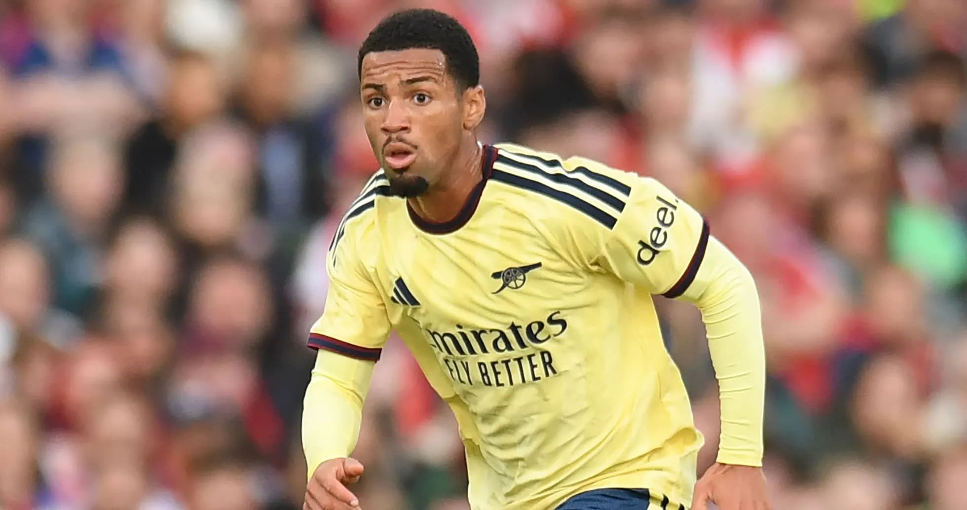 Player in Arsenal jersey running during match Player in Arsenal jersey running during match
