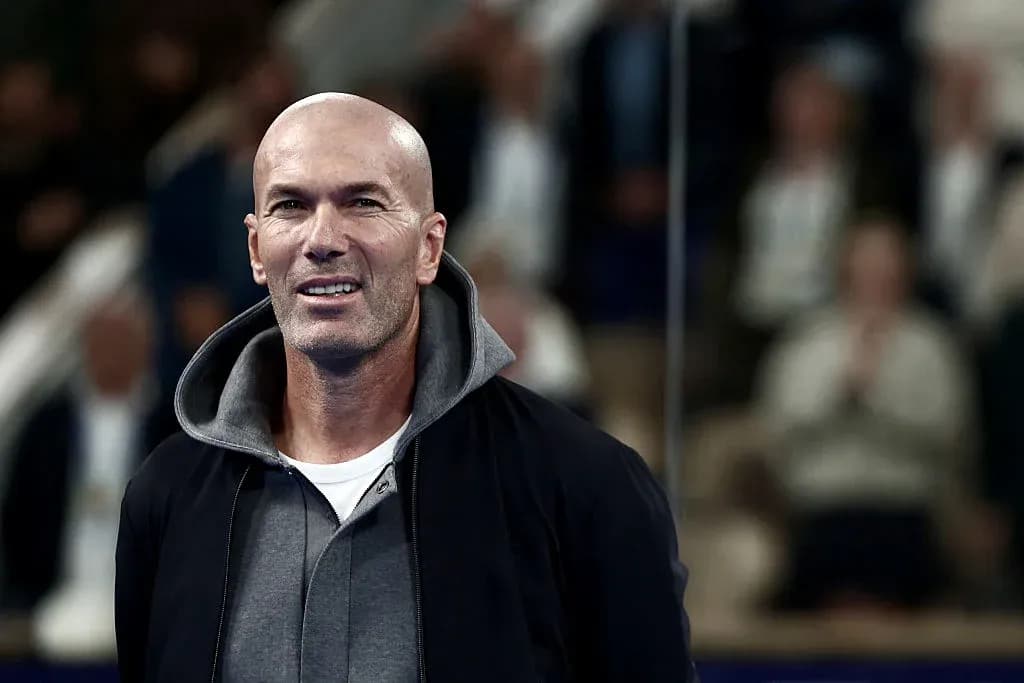 Man in a hoodie smiling at an event Man in a hoodie smiling at an event