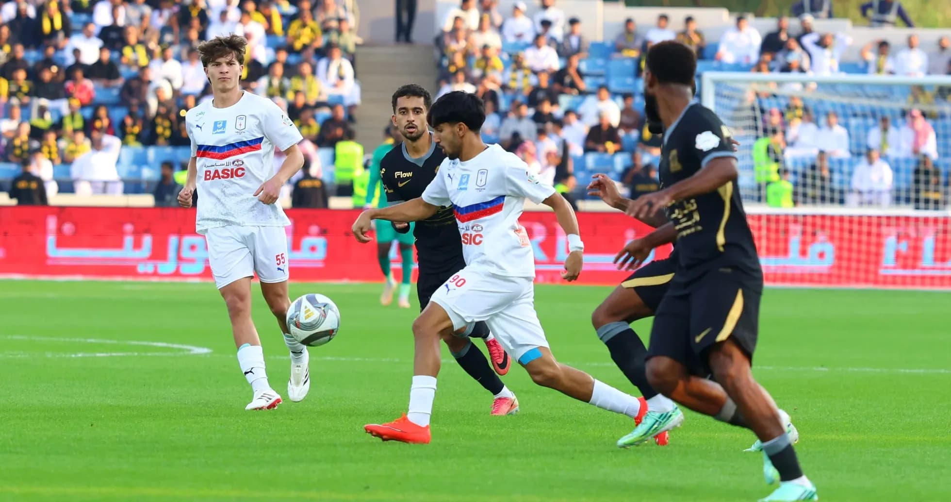 Players competing for the ball during football match Players competing for the ball during football match