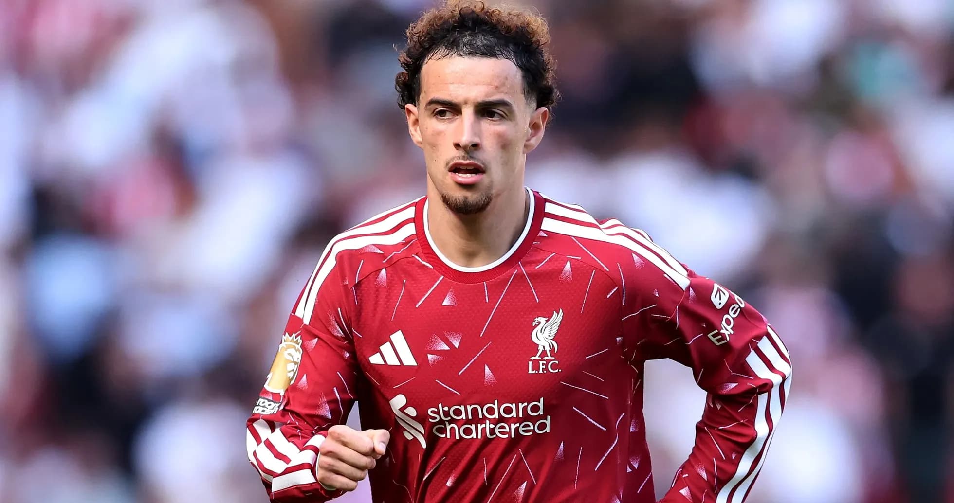 Player in Liverpool jersey running on the pitch Player in Liverpool jersey running on the pitch