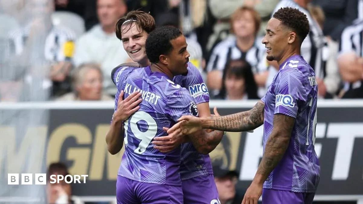 Three players celebrating a goal on the pitch Three players celebrating a goal on the pitch