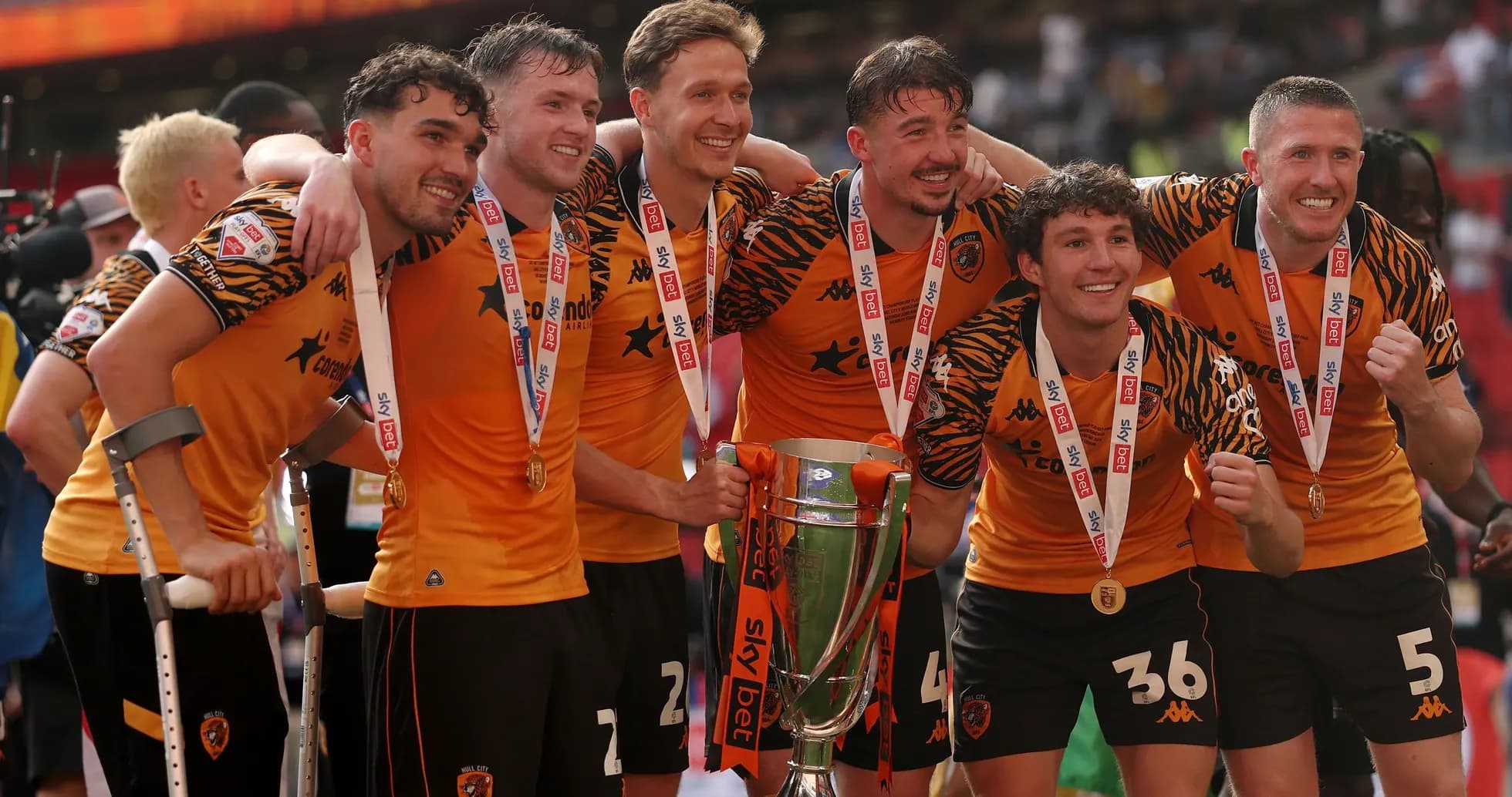 Players celebrating with trophy after winning match Players celebrating with trophy after winning match