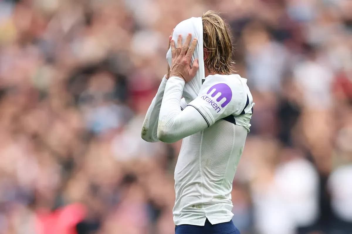 Player pulling shirt over head in frustration during match Player pulling shirt over head in frustration during match