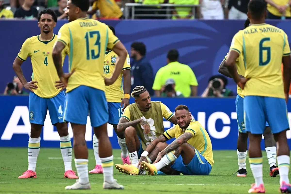 Neymar sitting on field with teammates surrounding Neymar sitting on field with teammates surrounding
