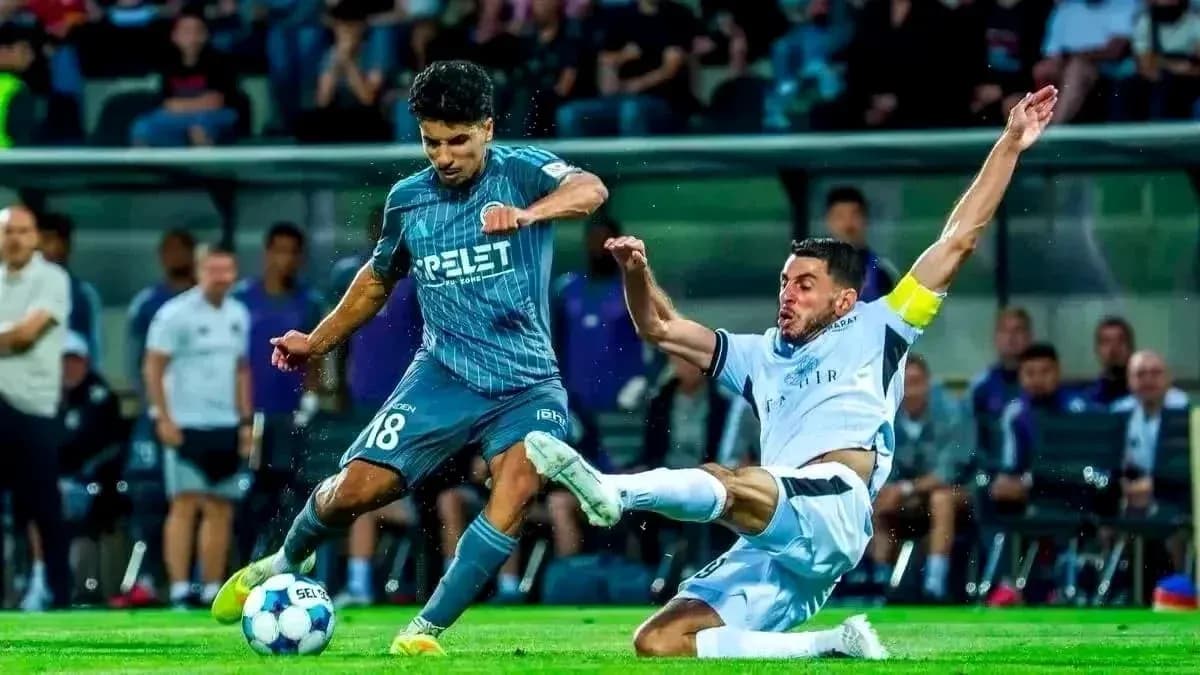 Player tackles opponent during UEFA Champions League match Player tackles opponent during UEFA Champions League match