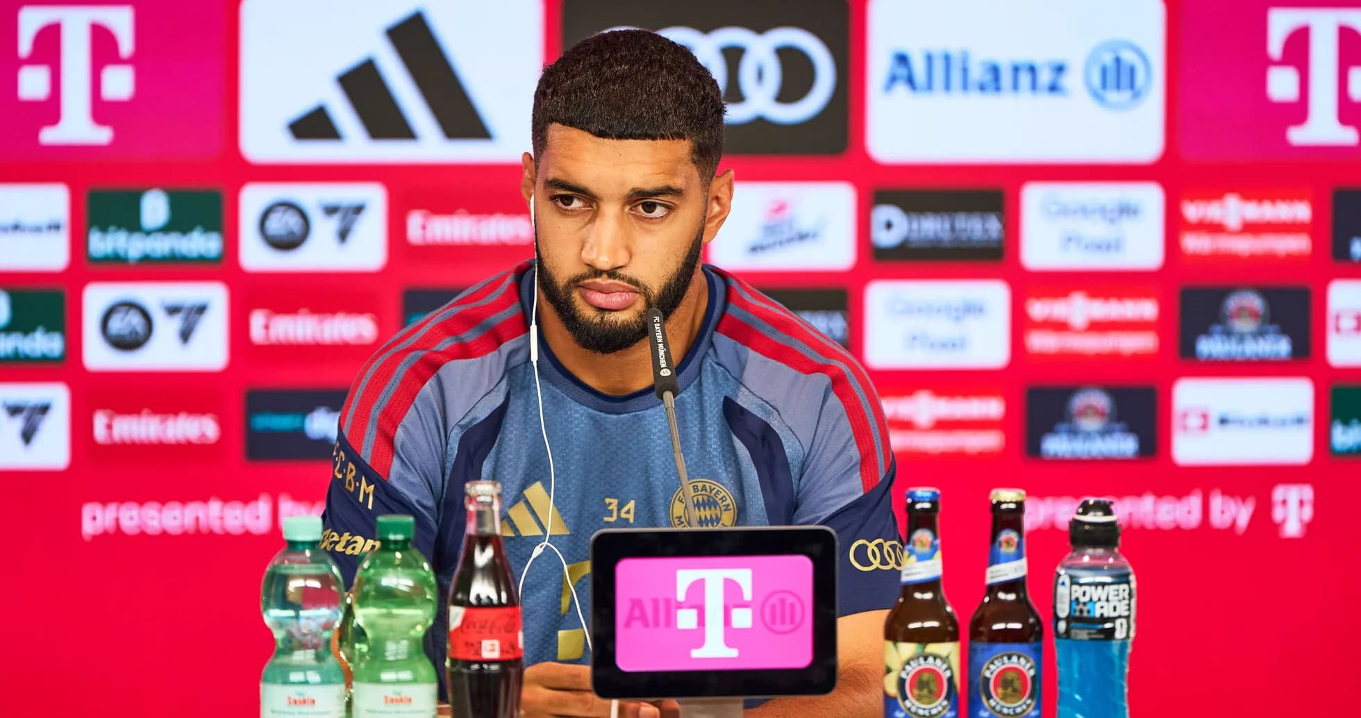 Player at press conference with sponsors' logos behind Player at press conference with sponsors' logos behind