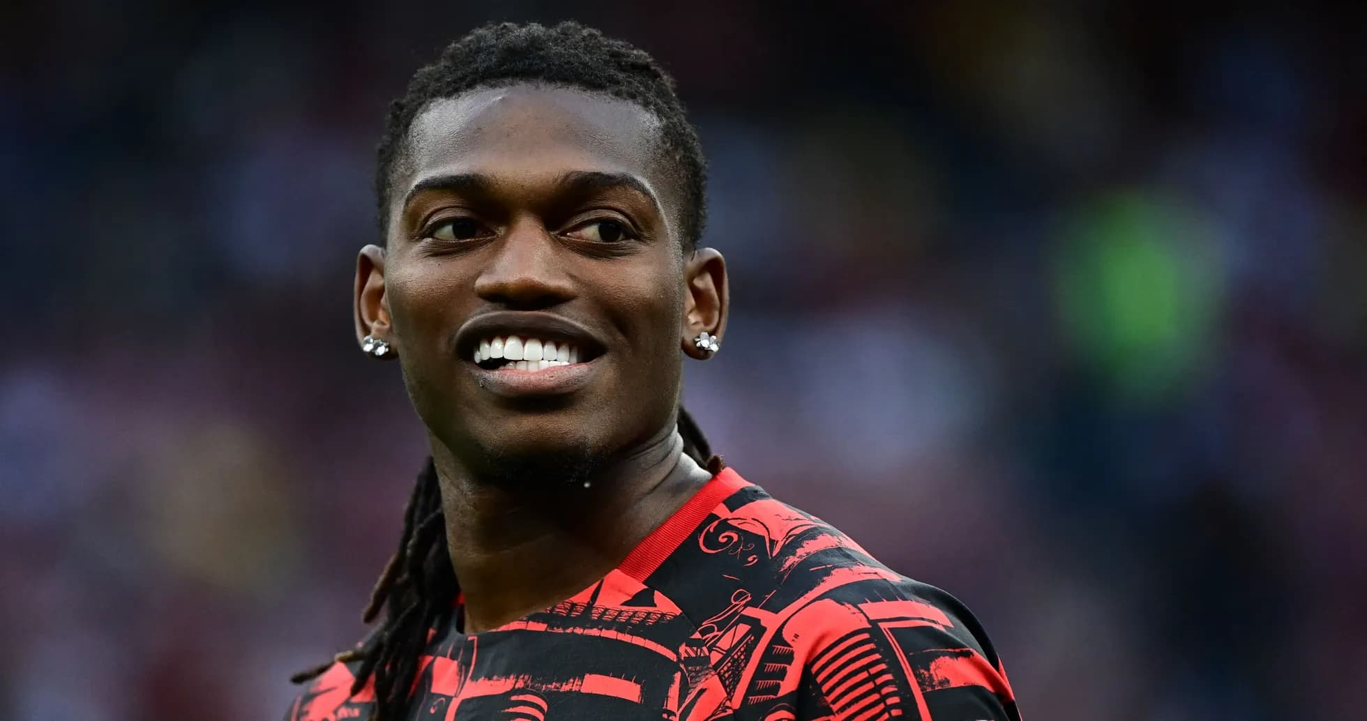 Player smiling in red and black jersey Player smiling in red and black jersey
