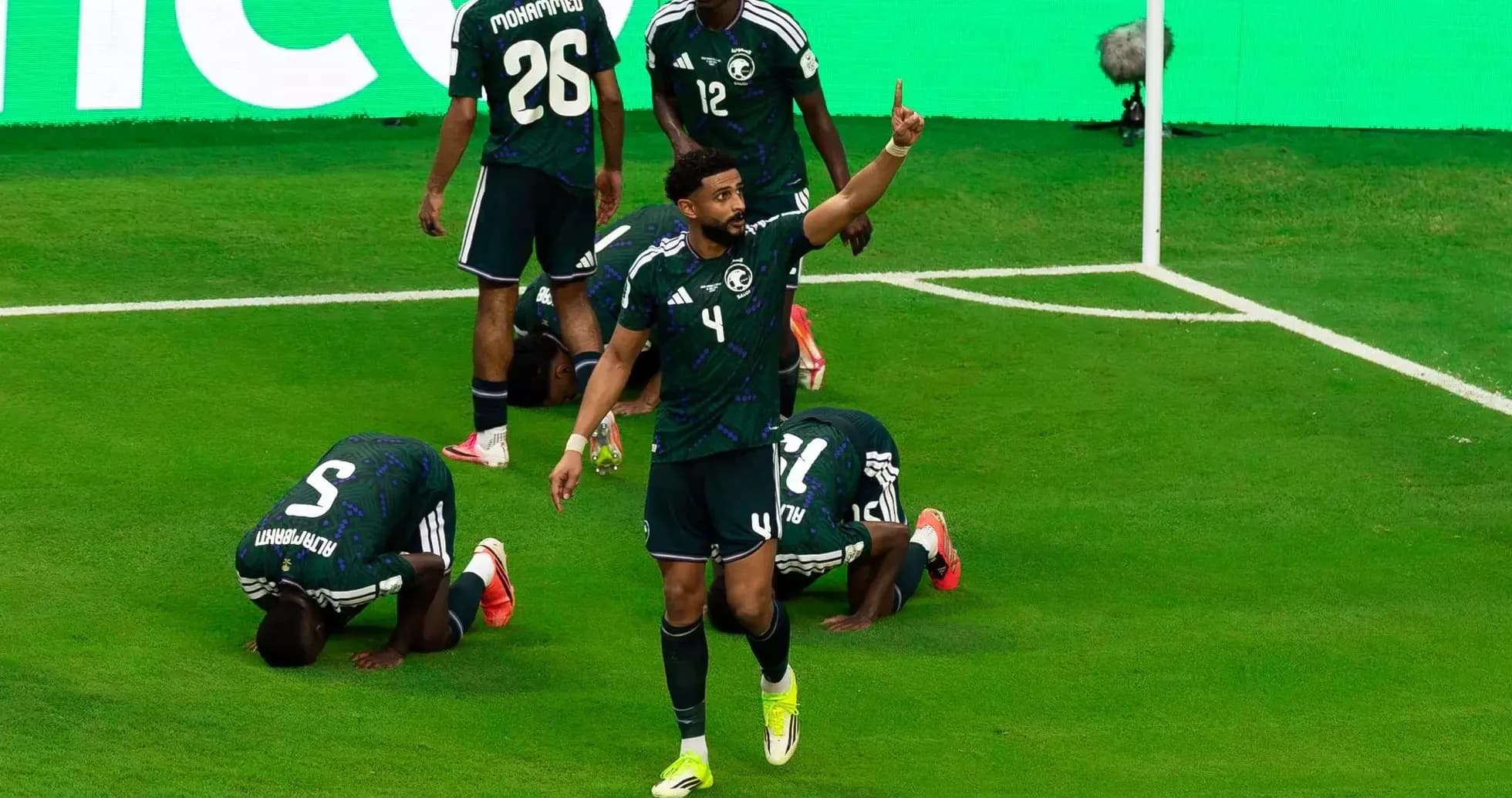 Saudi Arabian players celebrating on the field Saudi Arabian players celebrating on the field