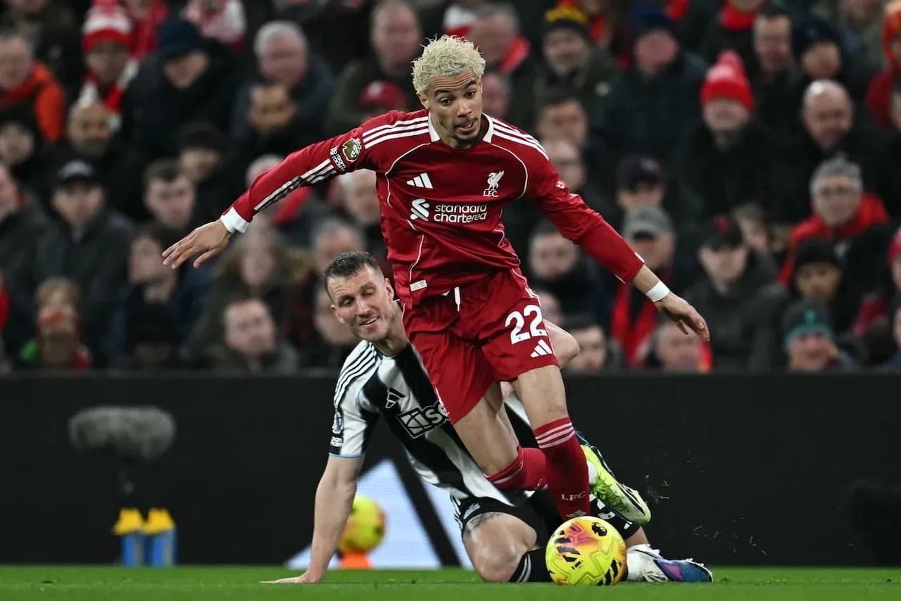 Liverpool player tackled by Newcastle defender Liverpool player tackled by Newcastle defender