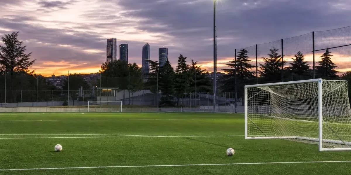 Soccer field with goalposts and sunset skyline Soccer field with goalposts and sunset skyline