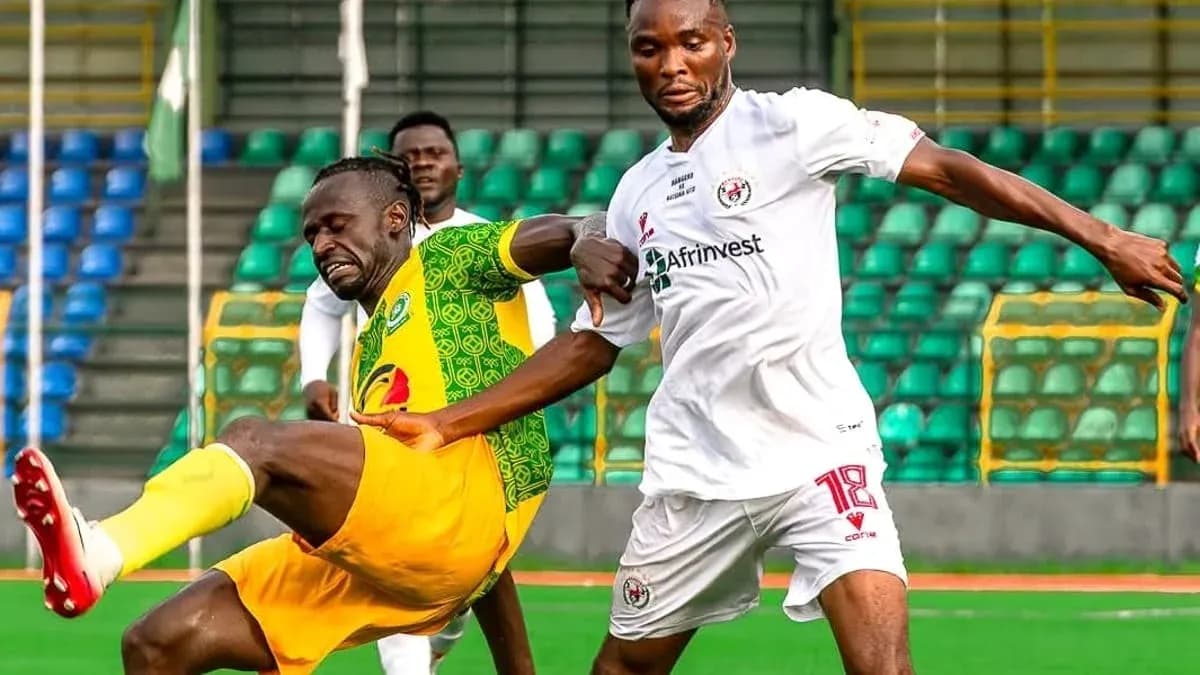 Katsina United player tackled by Rivers United opponent Katsina United player tackled by Rivers United opponent