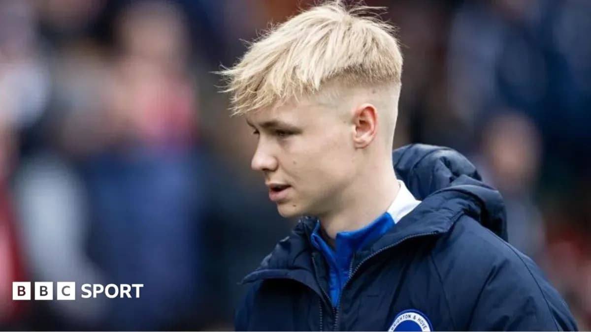 Player in team jacket on sidelines during match Player in team jacket on sidelines during match