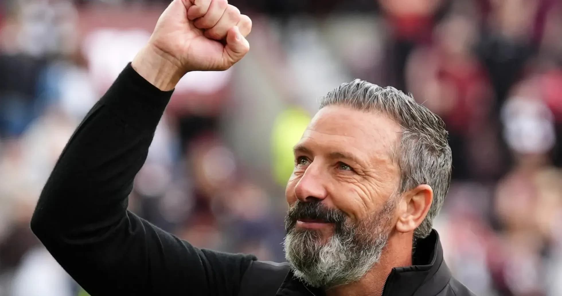Coach celebrating with a raised fist during match Coach celebrating with a raised fist during match