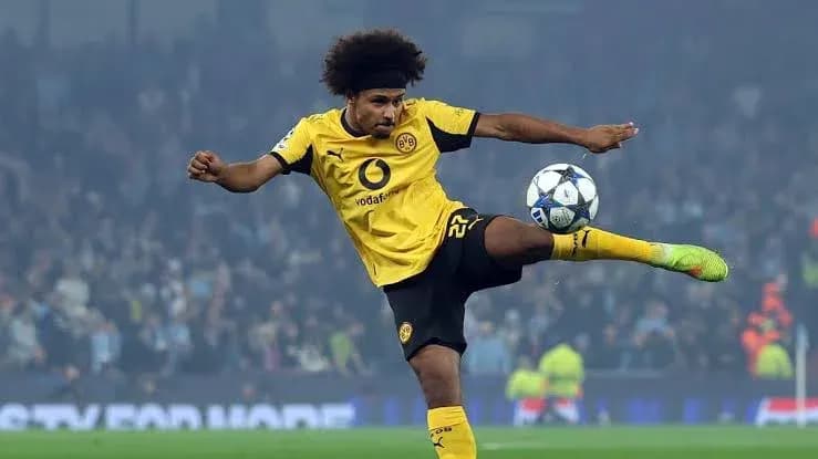 Player kicking the ball during a match Player kicking the ball during a match