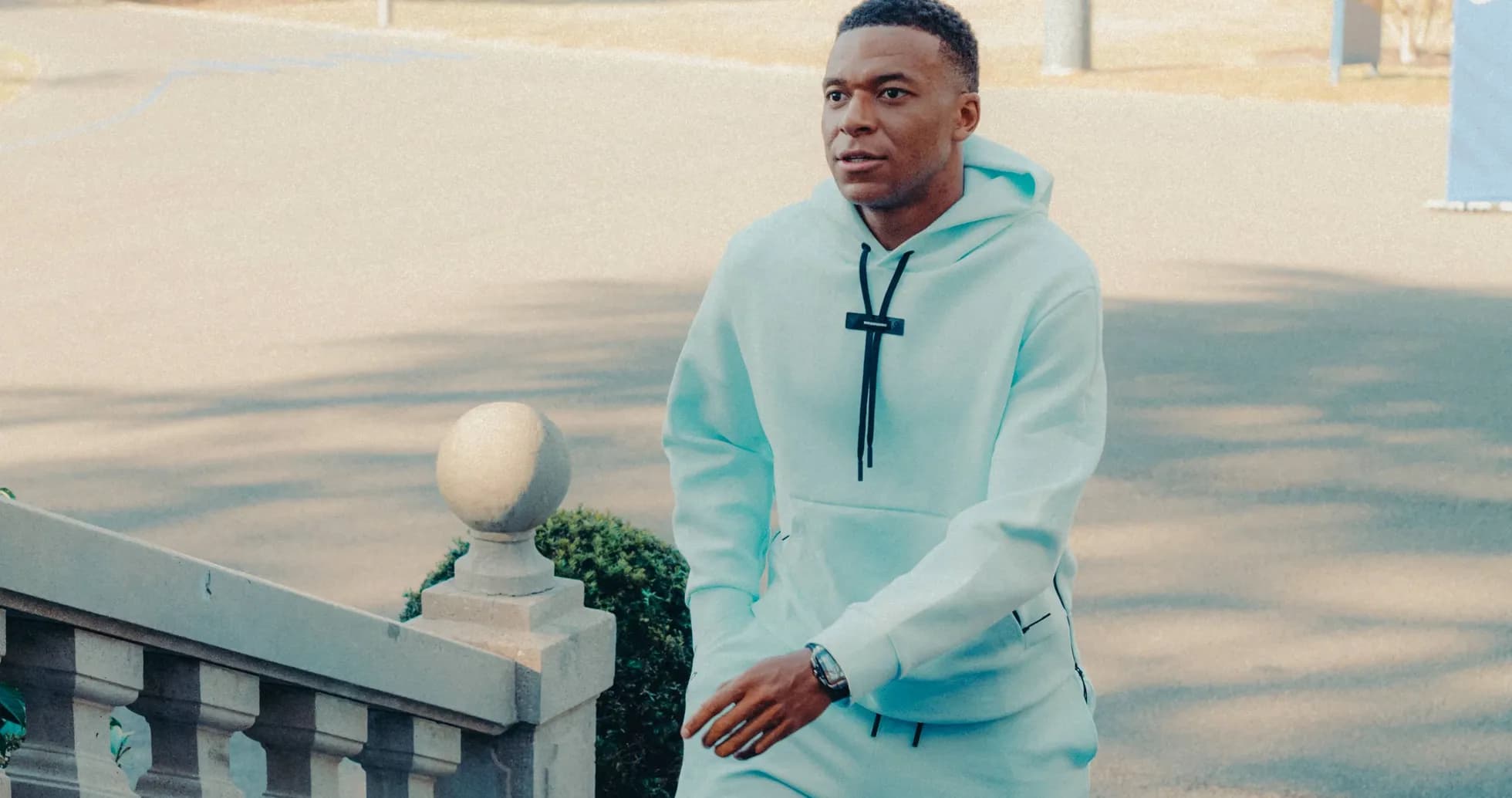 Player walking up stairs in light blue hoodie Player walking up stairs in light blue hoodie