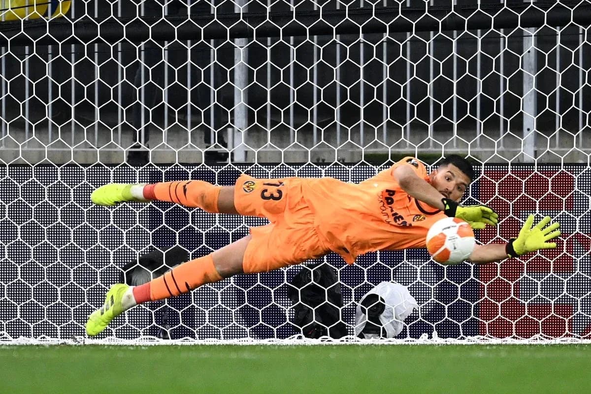 Goalkeeper diving to save a penalty kick Goalkeeper diving to save a penalty kick