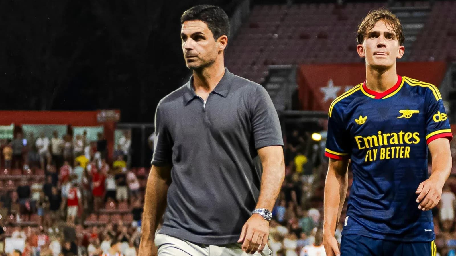 Manager and player walking off the pitch Manager and player walking off the pitch