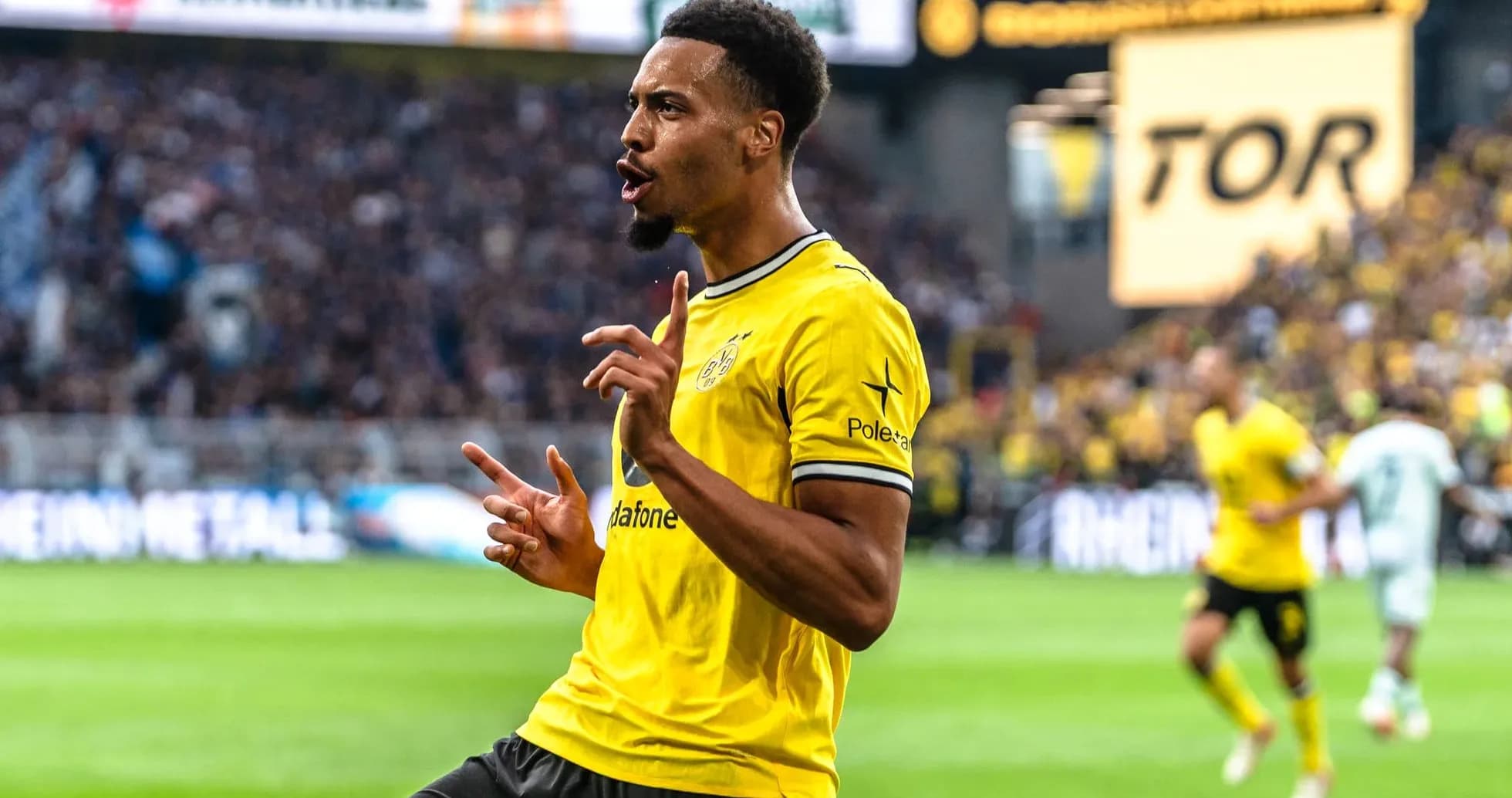 Player celebrating a goal in yellow jersey Player celebrating a goal in yellow jersey