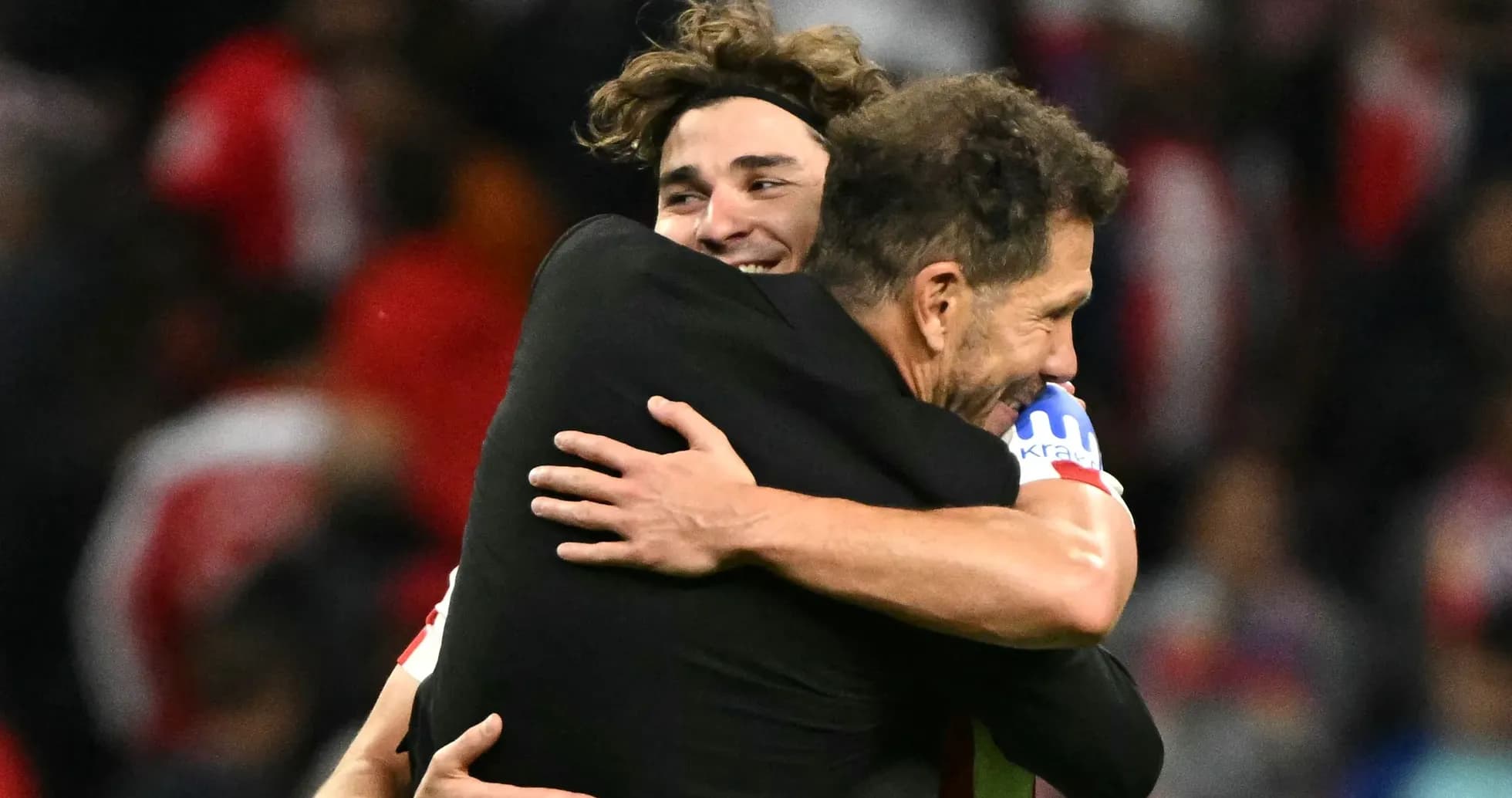 Players embracing after a successful match celebration Players embracing after a successful match celebration