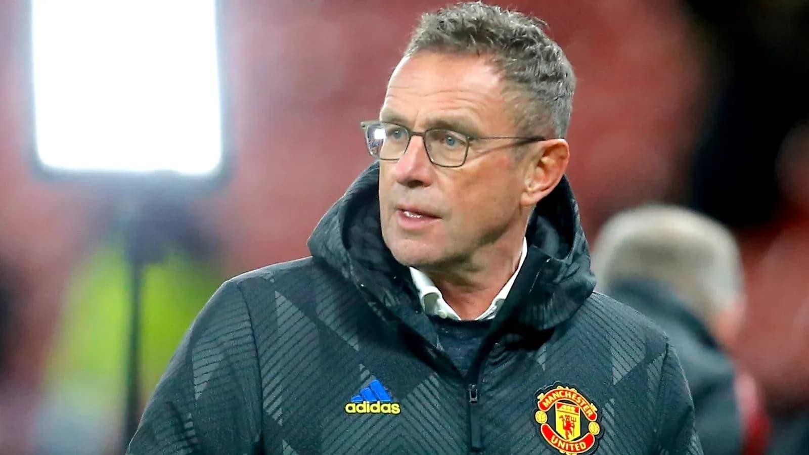 Coach in Manchester United jacket during match Coach in Manchester United jacket during match
