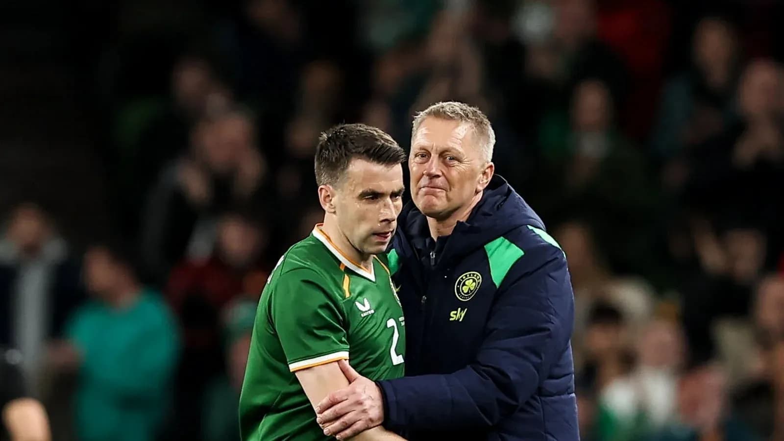 Manager embracing player during a football match Manager embracing player during a football match