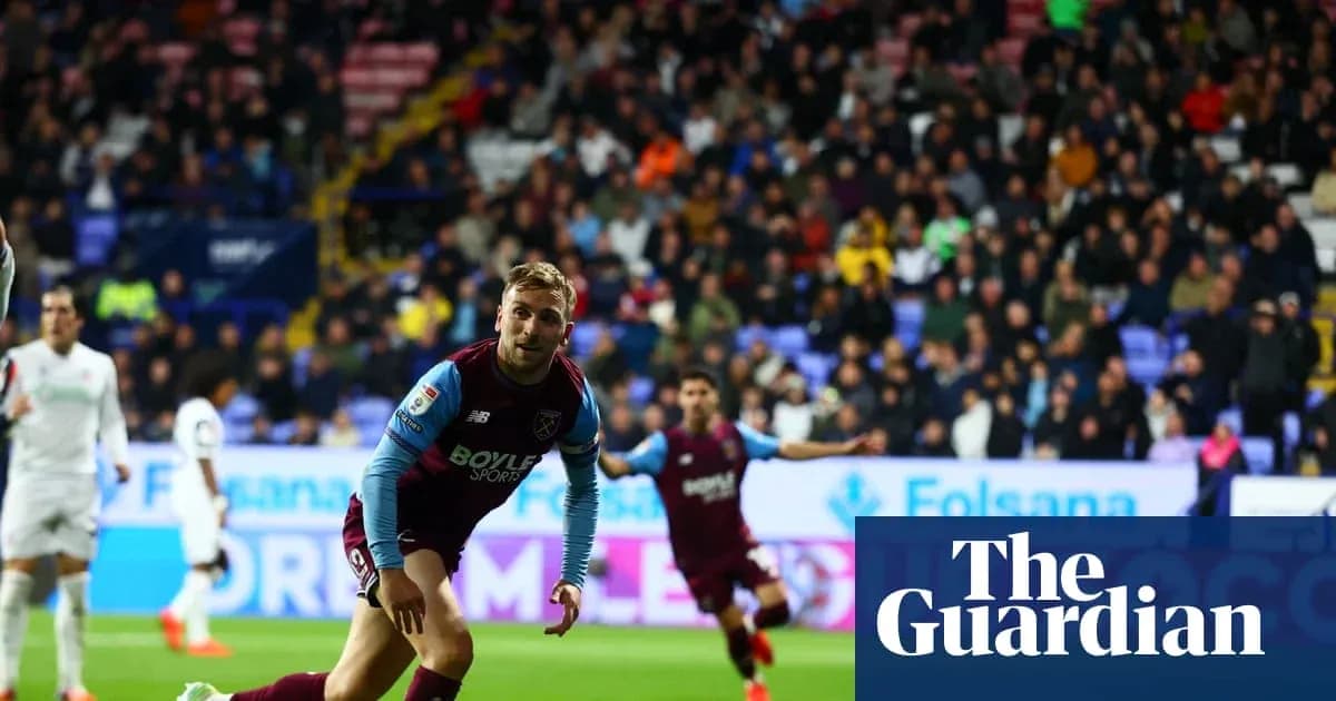 Player in maroon kit celebrating during football match Player in maroon kit celebrating during football match