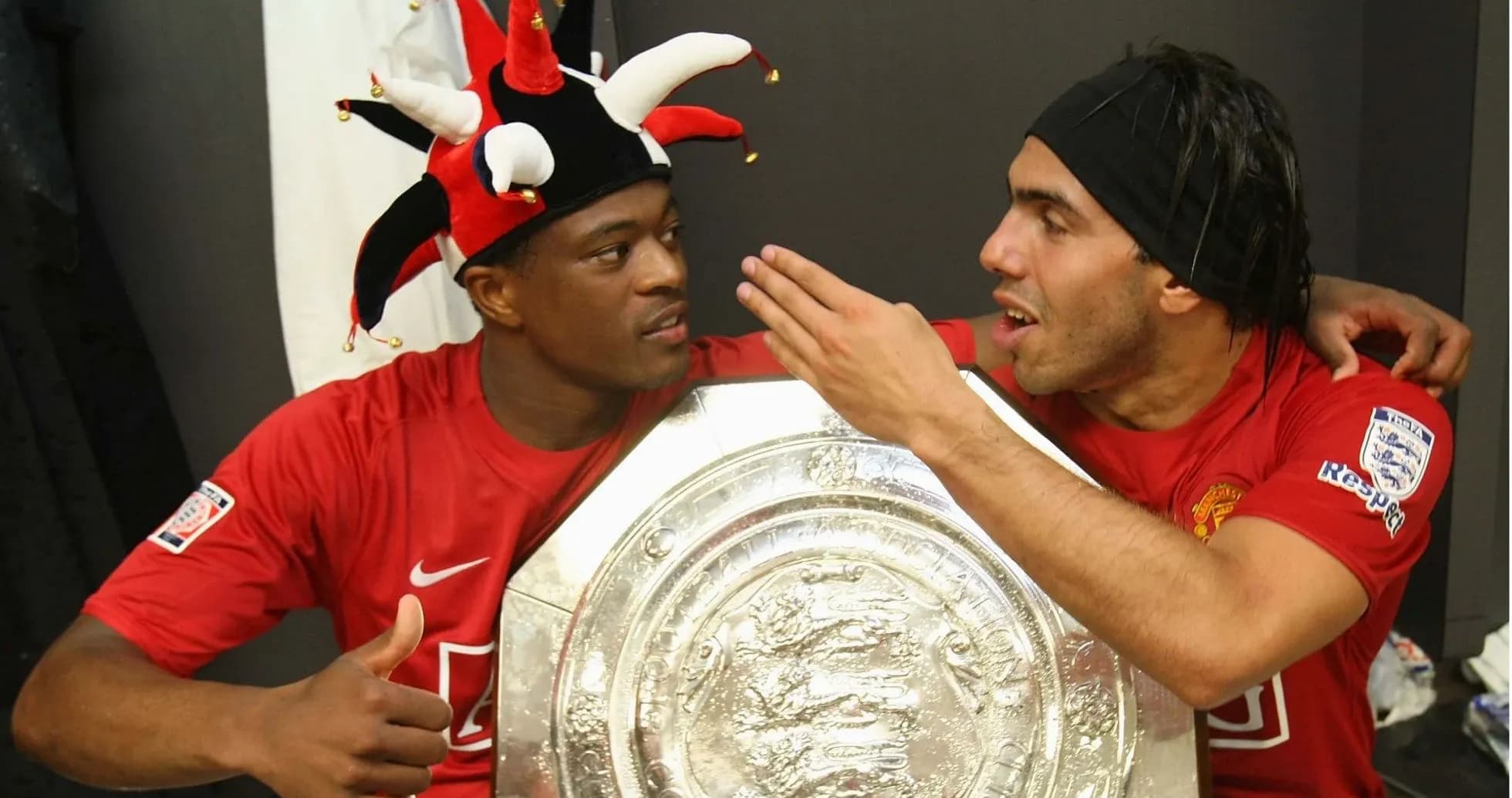 Two players celebrating with a trophy in locker room Two players celebrating with a trophy in locker room