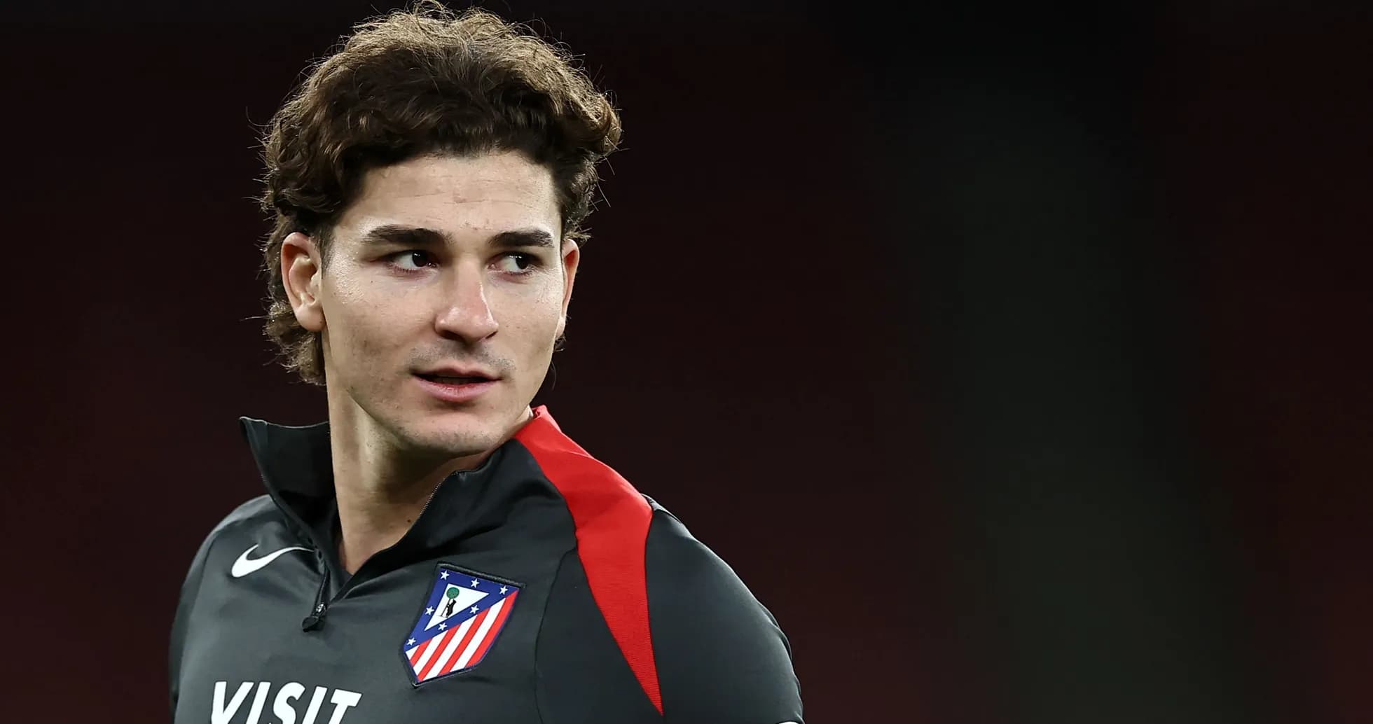 Player in Atlético Madrid training gear looking off camera Player in Atlético Madrid training gear looking off camera