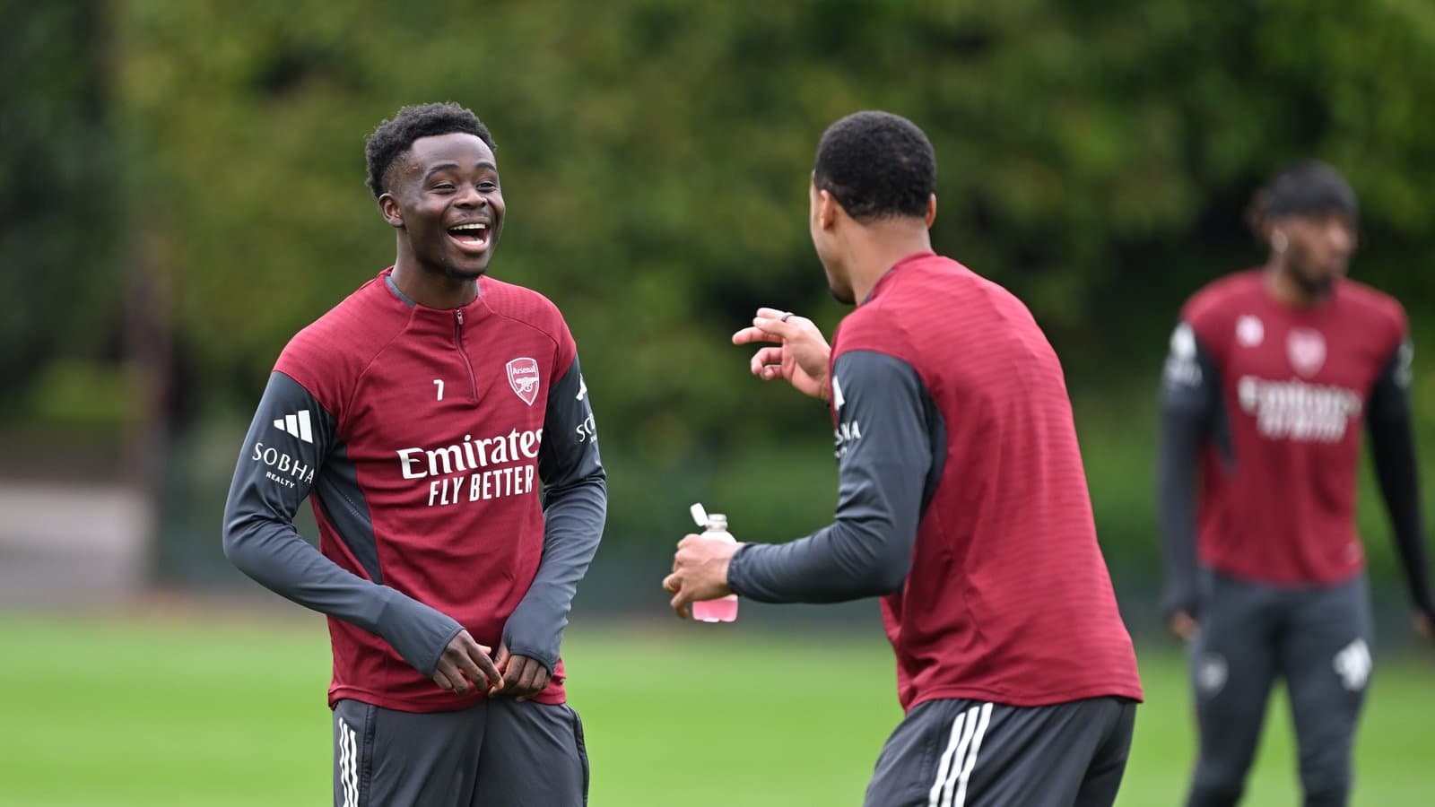 Two Arsenal players laughing during training session Two Arsenal players laughing during training session