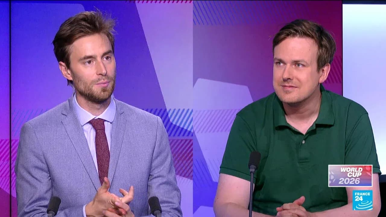 Two analysts discussing World Cup 2026 on set Two analysts discussing World Cup 2026 on set