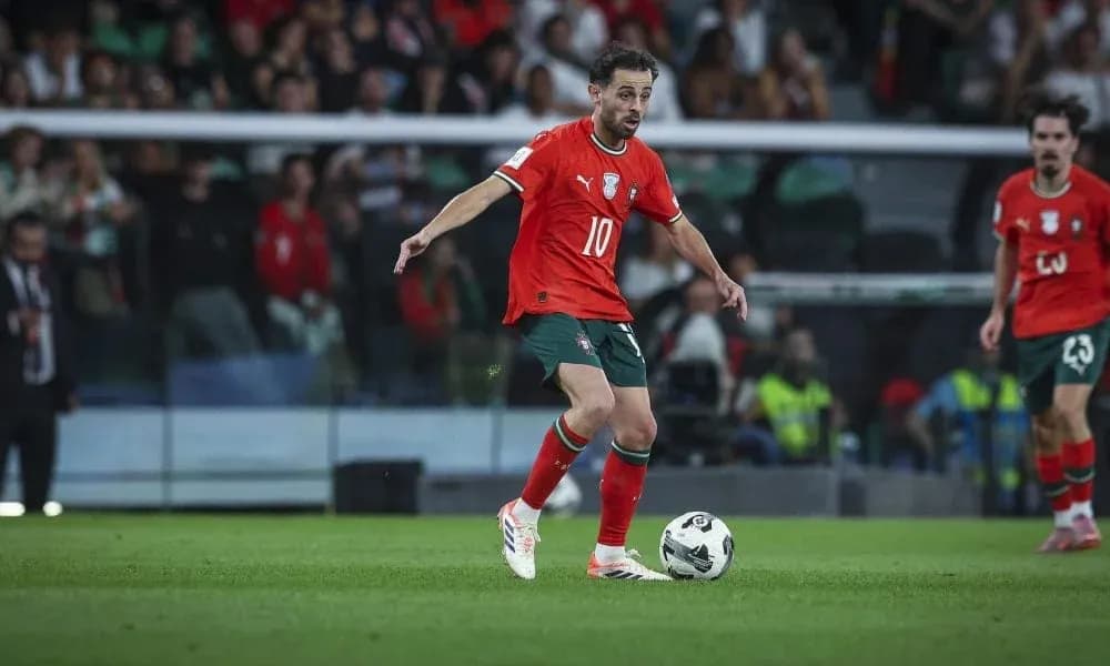 Player in red jersey controlling the ball on field Player in red jersey controlling the ball on field