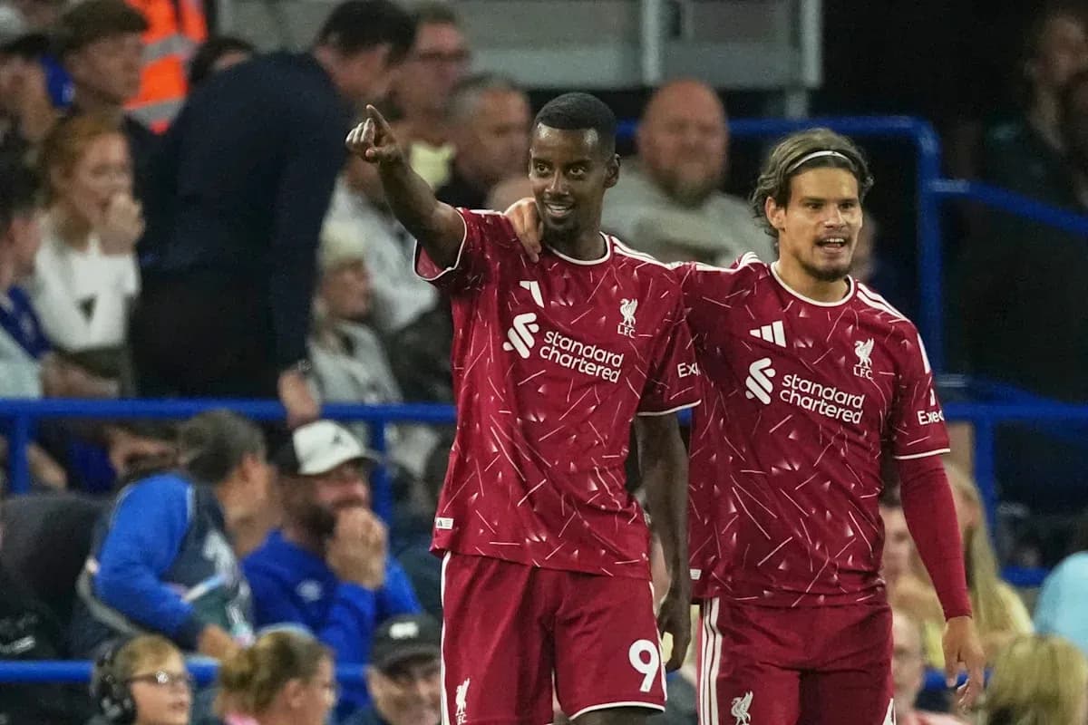 Two Liverpool players celebrating a goal on field Two Liverpool players celebrating a goal on field