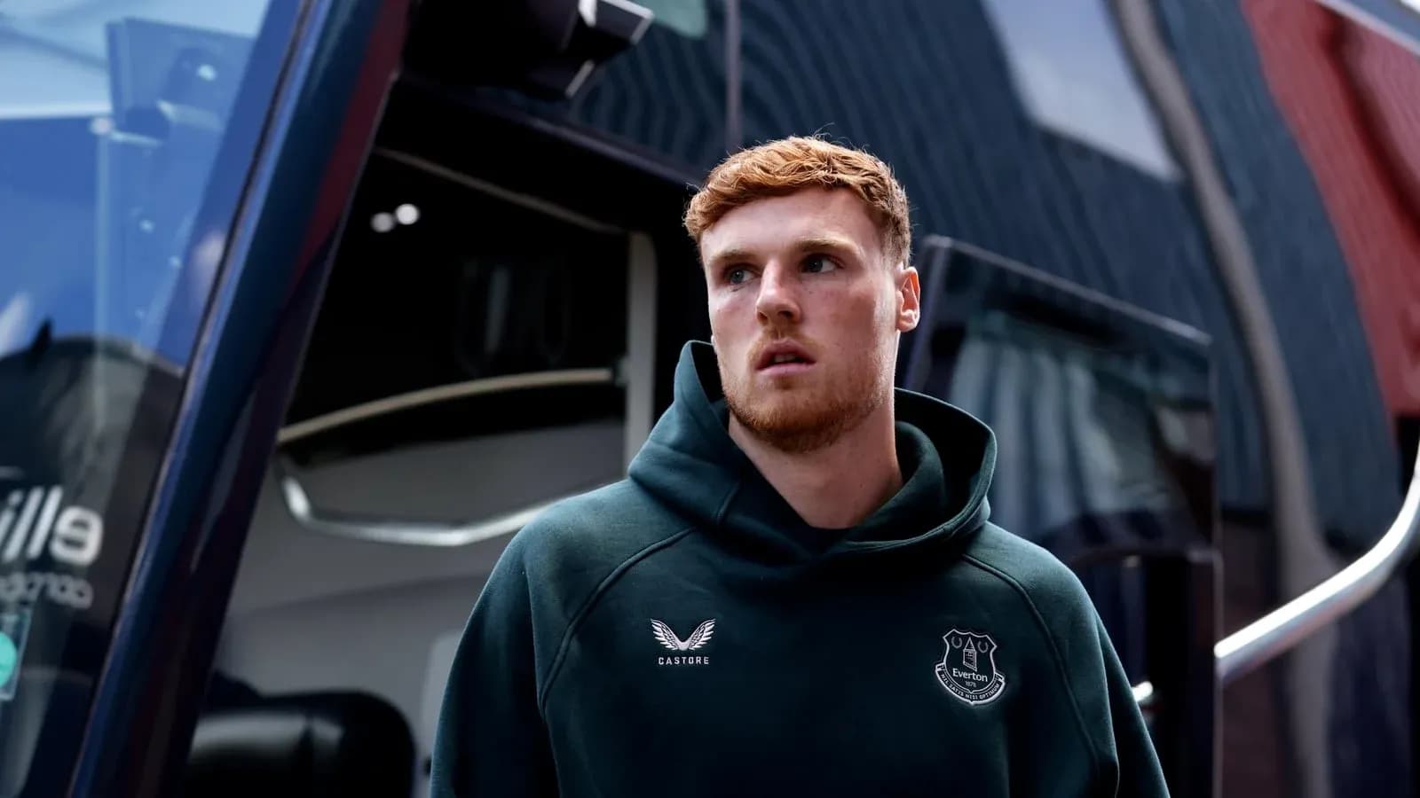 Player wearing Everton hoodie near team bus Player wearing Everton hoodie near team bus