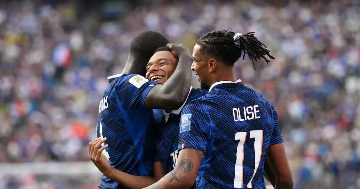 Three players celebrating a goal on the field Three players celebrating a goal on the field