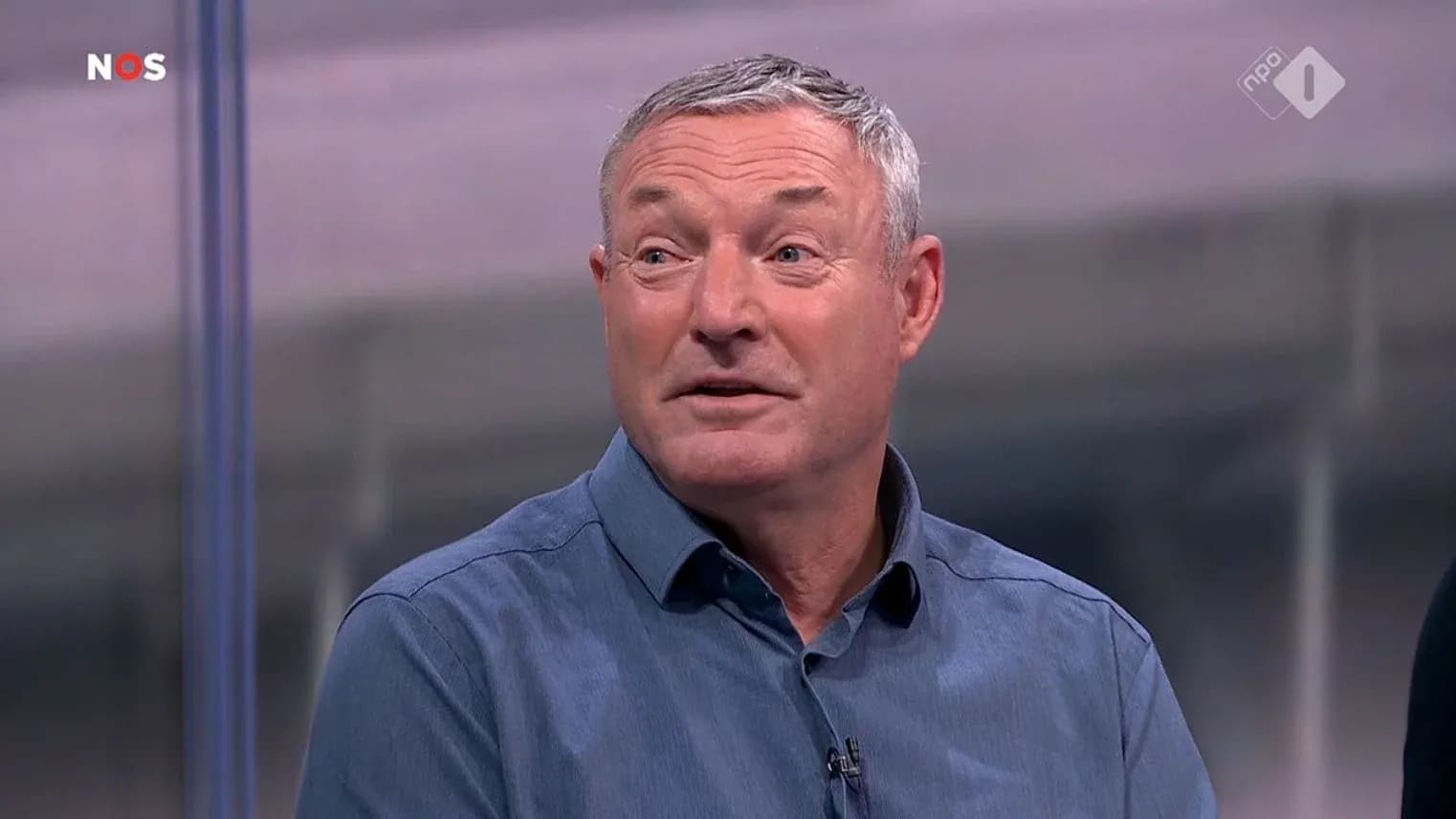 Man speaking during sports discussion on set Man speaking during sports discussion on set