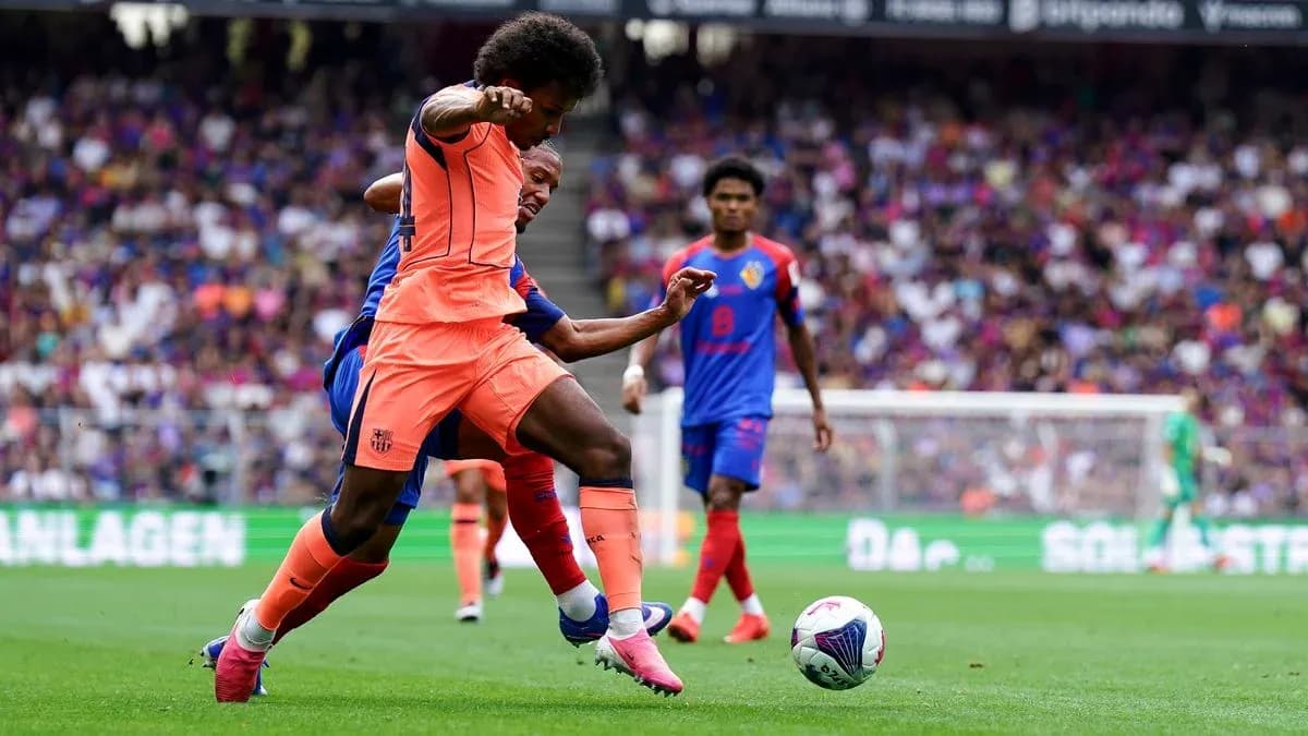 Player in orange tackling opponent in blue during match Player in orange tackling opponent in blue during match